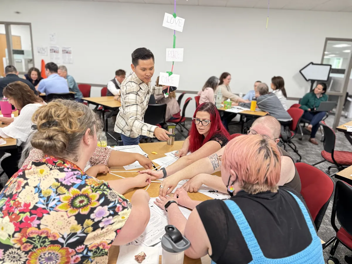 Ton Nguyen facilitating an interactive workplace communication workshop with adult participants