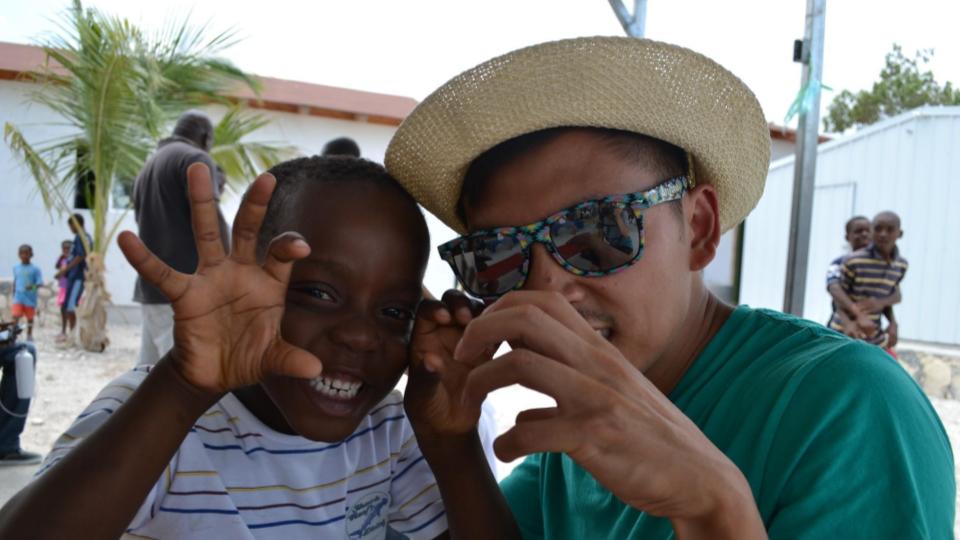Catholic youth speaker Ton Nguyen sharing a joyful moment with a young person during a ministry experience