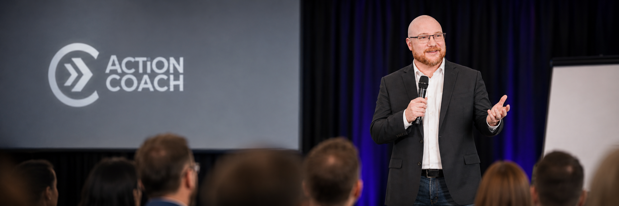 ActionCOACH business coach speaking to an audience of business leaders and entrepreneurs