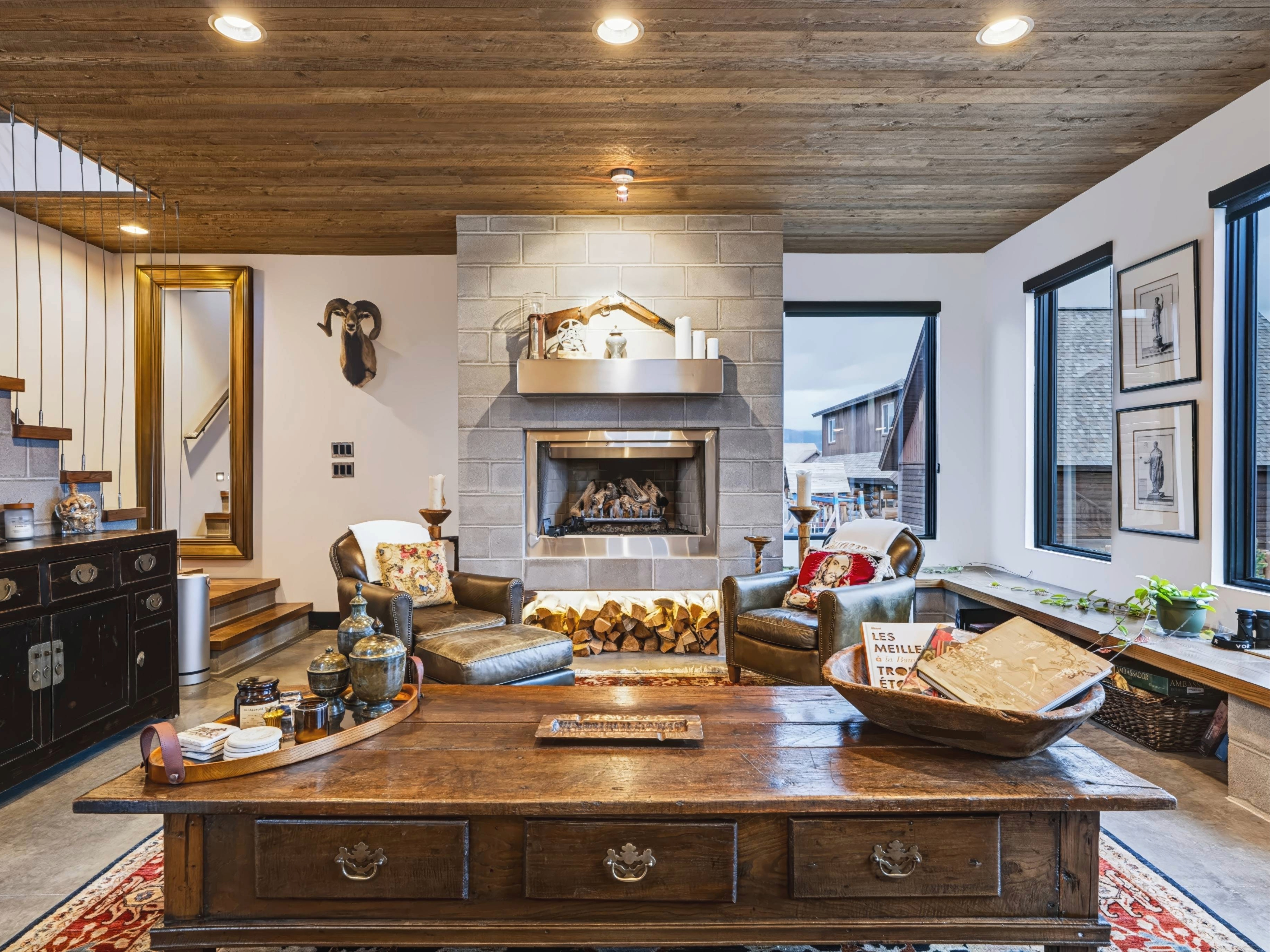 Luxury mountain living room with stone fireplace