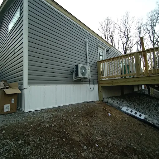 Outdoor ductless mini split heat pump condenser unit mounted on exterior wall in Sugar Land