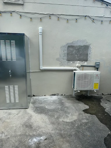 Outdoor mini split condenser with line set cover installed on exterior wall in Boerne, TX