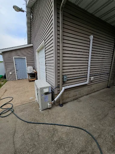 Outdoor ductless mini split condenser unit installed beside exterior wall in Pearland area