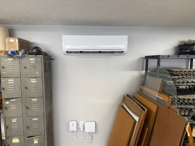 Sleek white ductless mini split indoor air handler mounted above storage lockers in Boerne