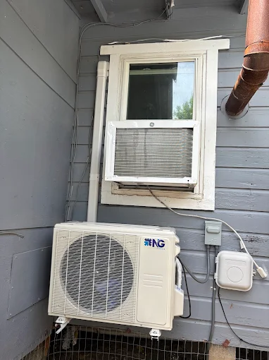 Wall-mounted outdoor mini split condenser unit in New Braunfels, TX