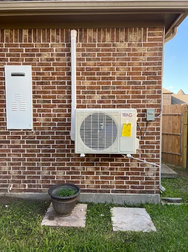 Outdoor ductless mini split condenser and line cover on brick exterior in Sugar Land