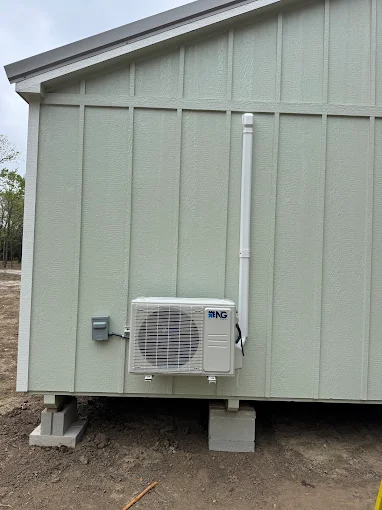 Outdoor mini split condenser unit mounted on exterior wall in Schertz, TX