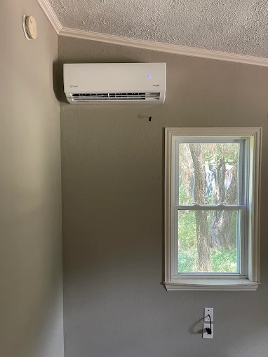 Dual-zone heat pump outdoor unit mounted on heavy-duty wall brackets