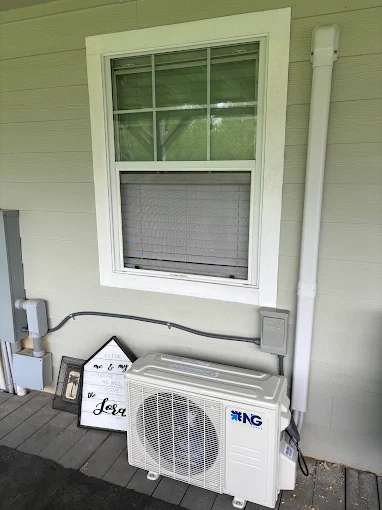 Clean outdoor mini split heat pump unit with line hide installed in Spring, Texas