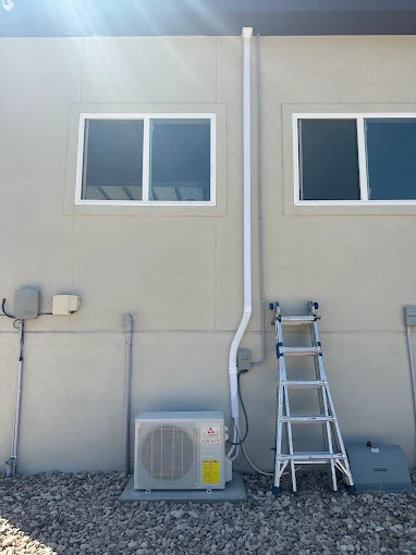 Clean wall-mounted line set cover and mini split condenser installation