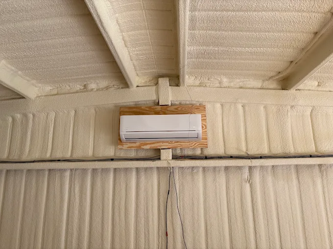 Spray foam insulated workshop ceiling with wall-mounted mini split unit