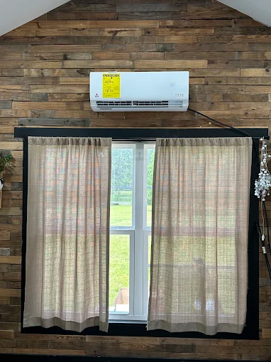 Indoor mini split wall unit mounted on accent wood wall in New Braunfels home