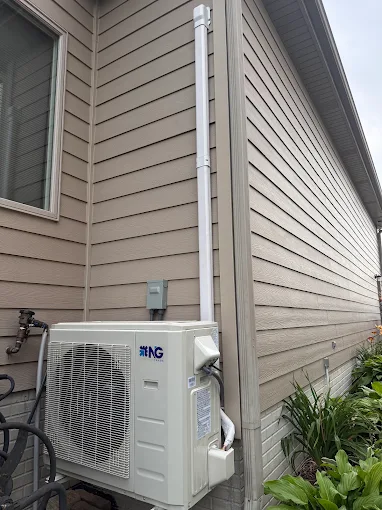 Outdoor mini split heat pump condenser with clean line hide cover in McKinney home