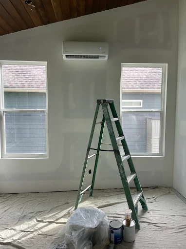 Wall-mounted ductless mini split indoor handler in room with vaulted ceiling in The Woodlands