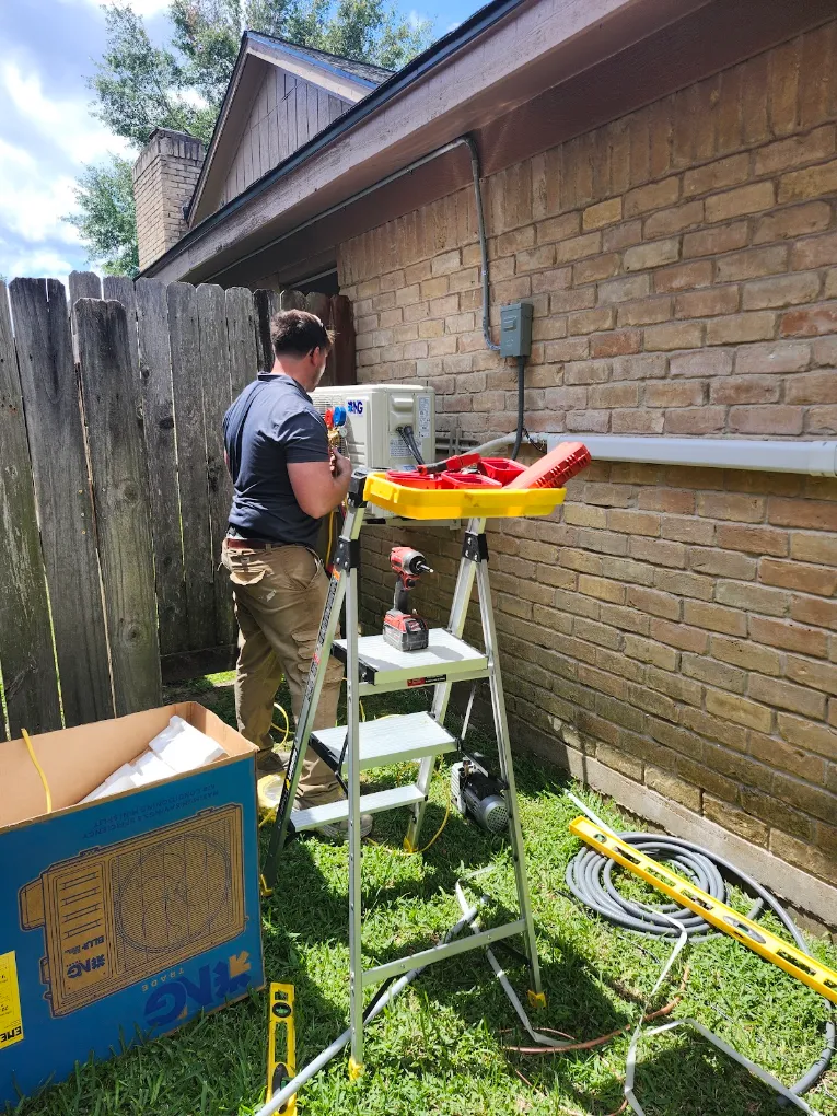 Outdoor mini split heat pump condenser unit mounted cleanly on exterior wall