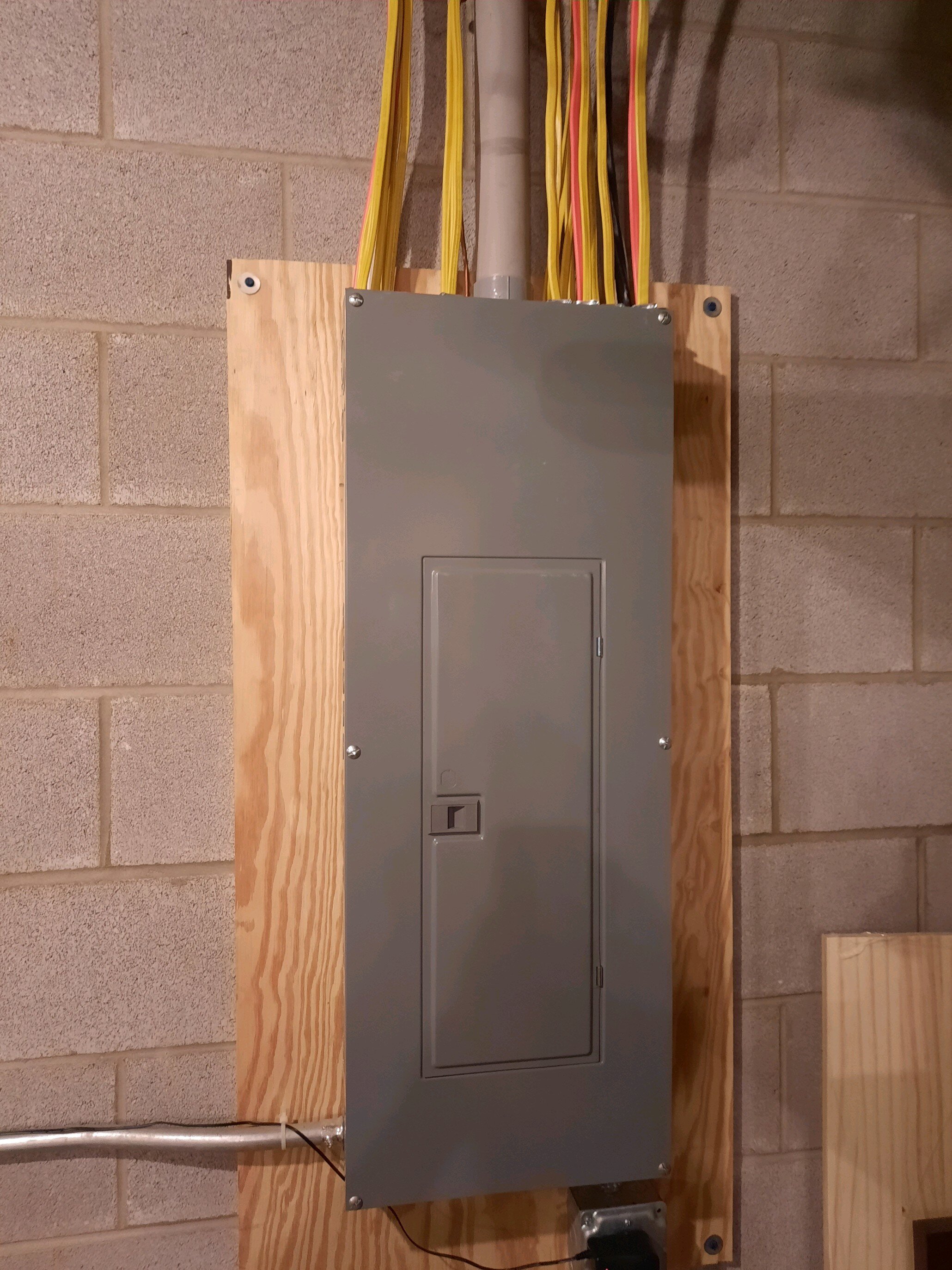 Coffing Electric electrician working on a commercial electrical panel