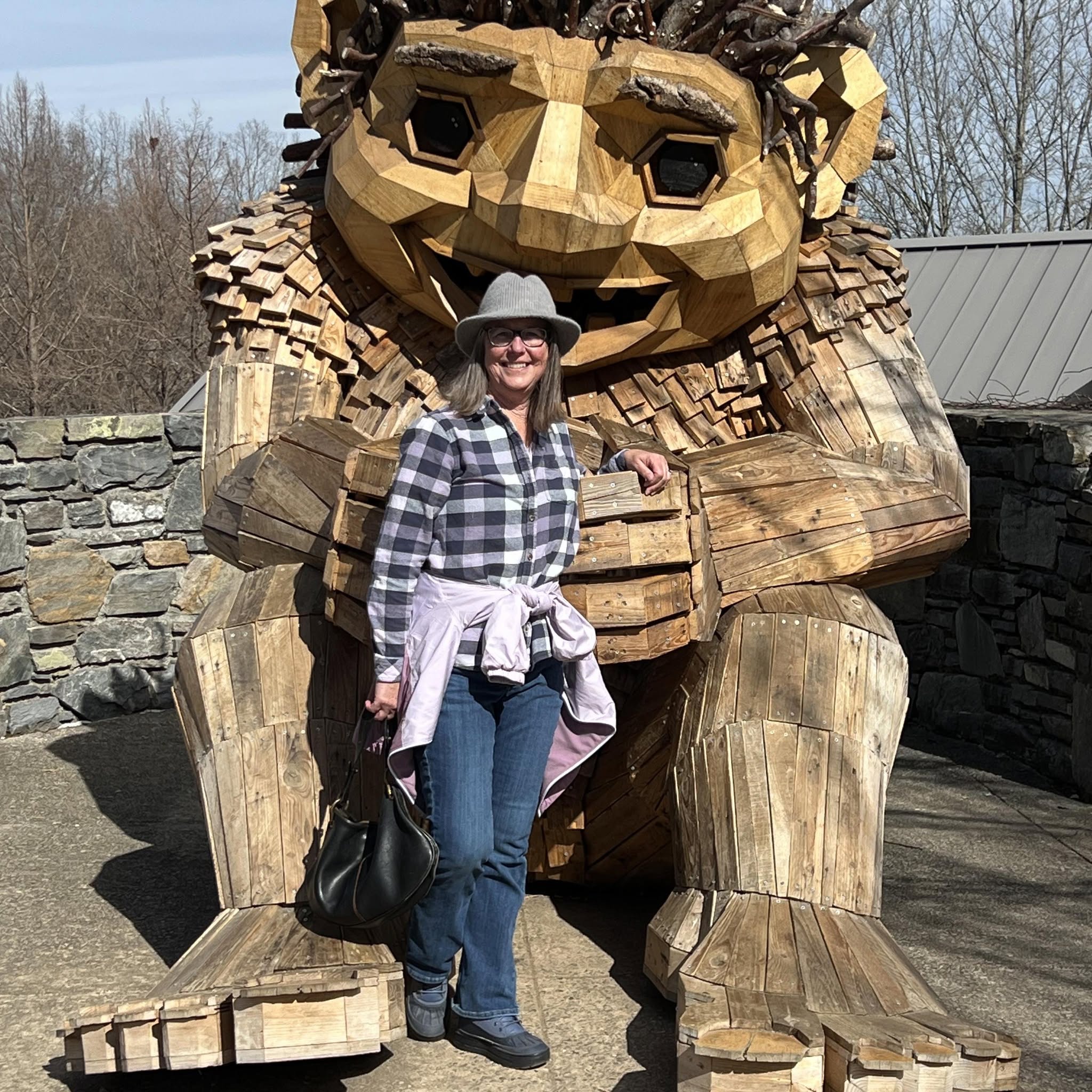 Lady Peach beside a carved wooden figure
