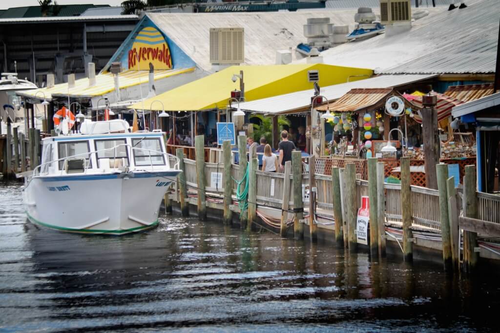 Waterfront dining along the Naples Riverwalk with boats and local restaurants