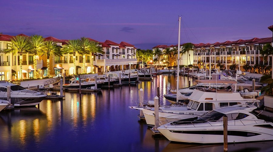 Modern Naples Bay marina with boats and waterfront development in Naples, Florida