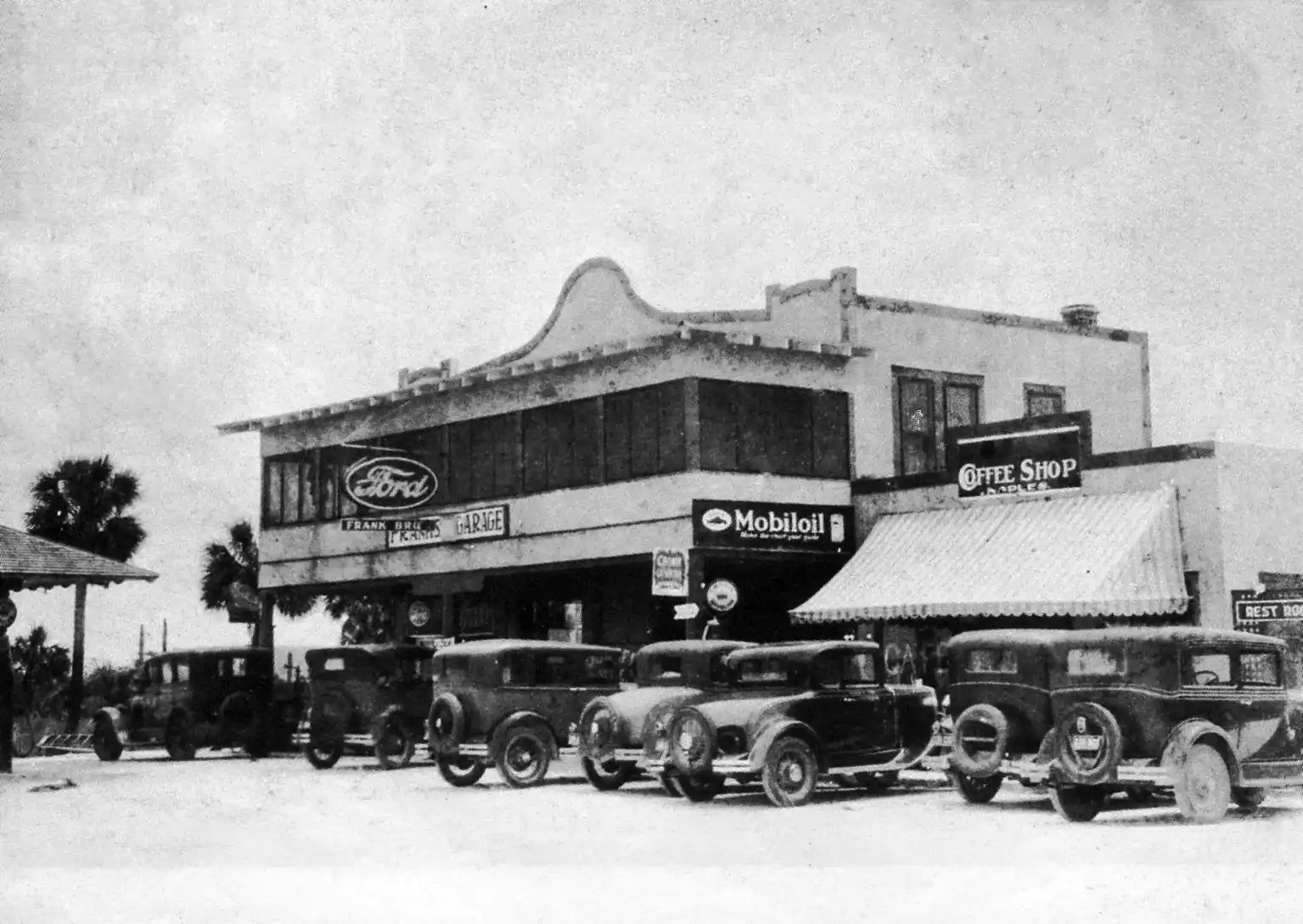 Frank Brothers Garage on Fifth Avenue in Naples, Florida during the 1920s with early automobiles parked outside