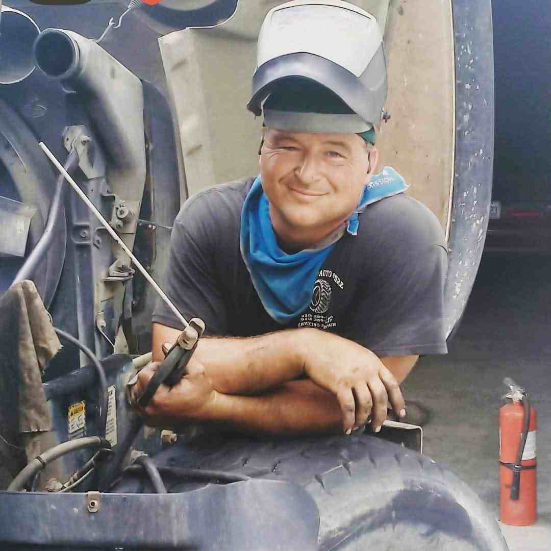 Certified mechanic performing welding and repair work on heavy equipment
