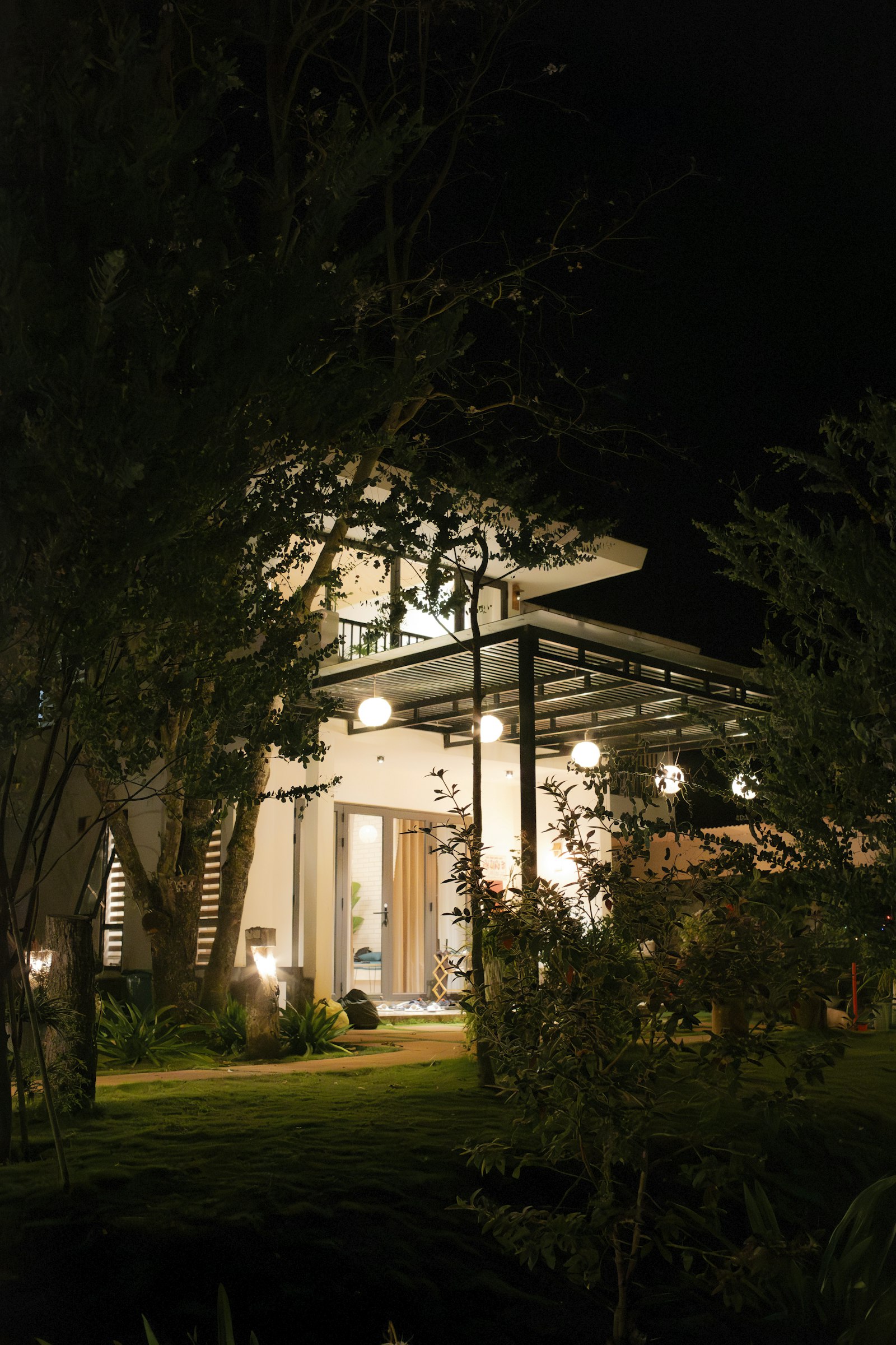 Modern home with architectural facade lighting and pathway lights