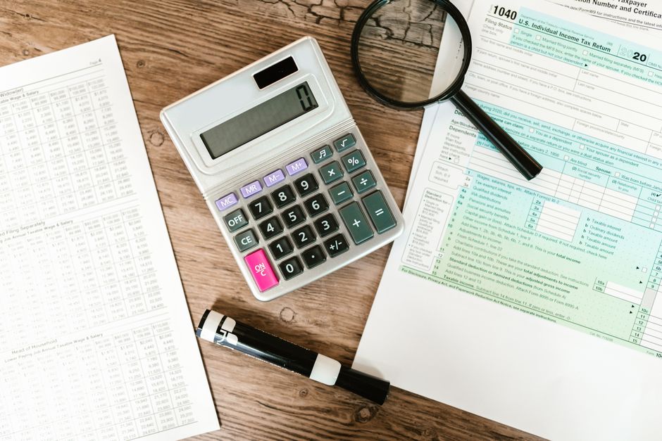 IRS tax debt negotiation forms and financial records spread across a desk