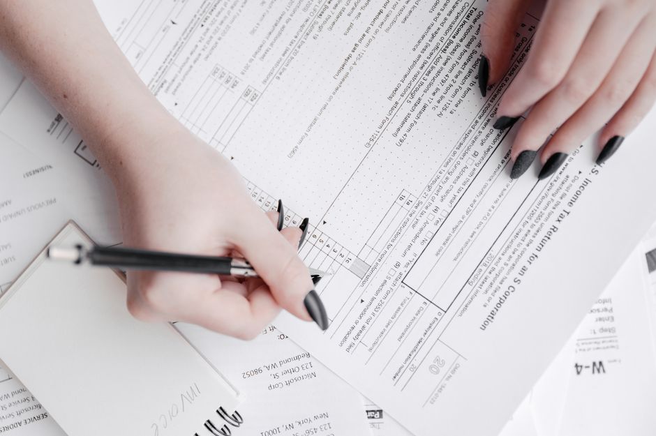 IRS Form 2210 underpayment penalty waiver section on a desk