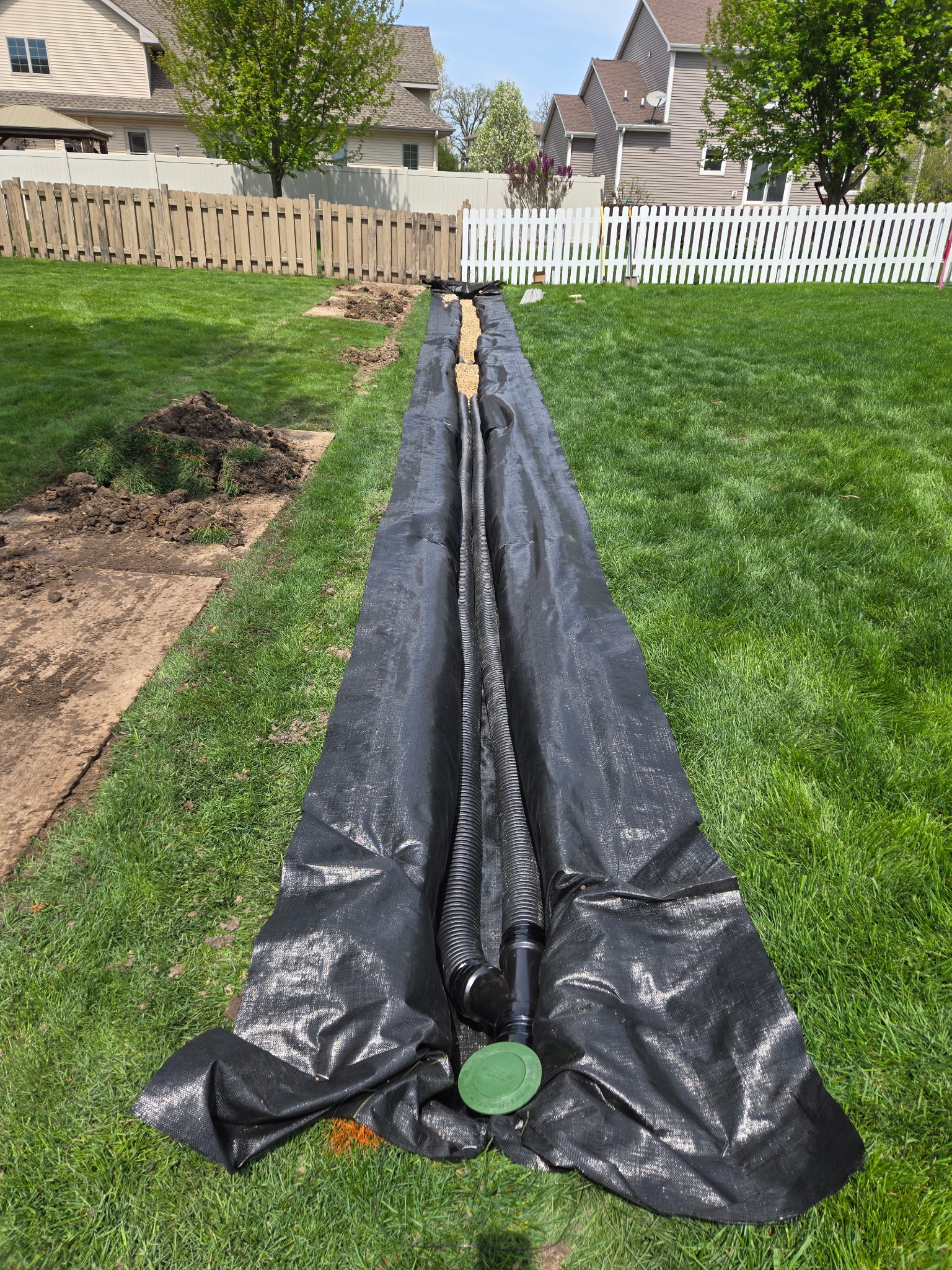 French drain pipe trench installation with geotextile fabric in Sun Prairie, WI