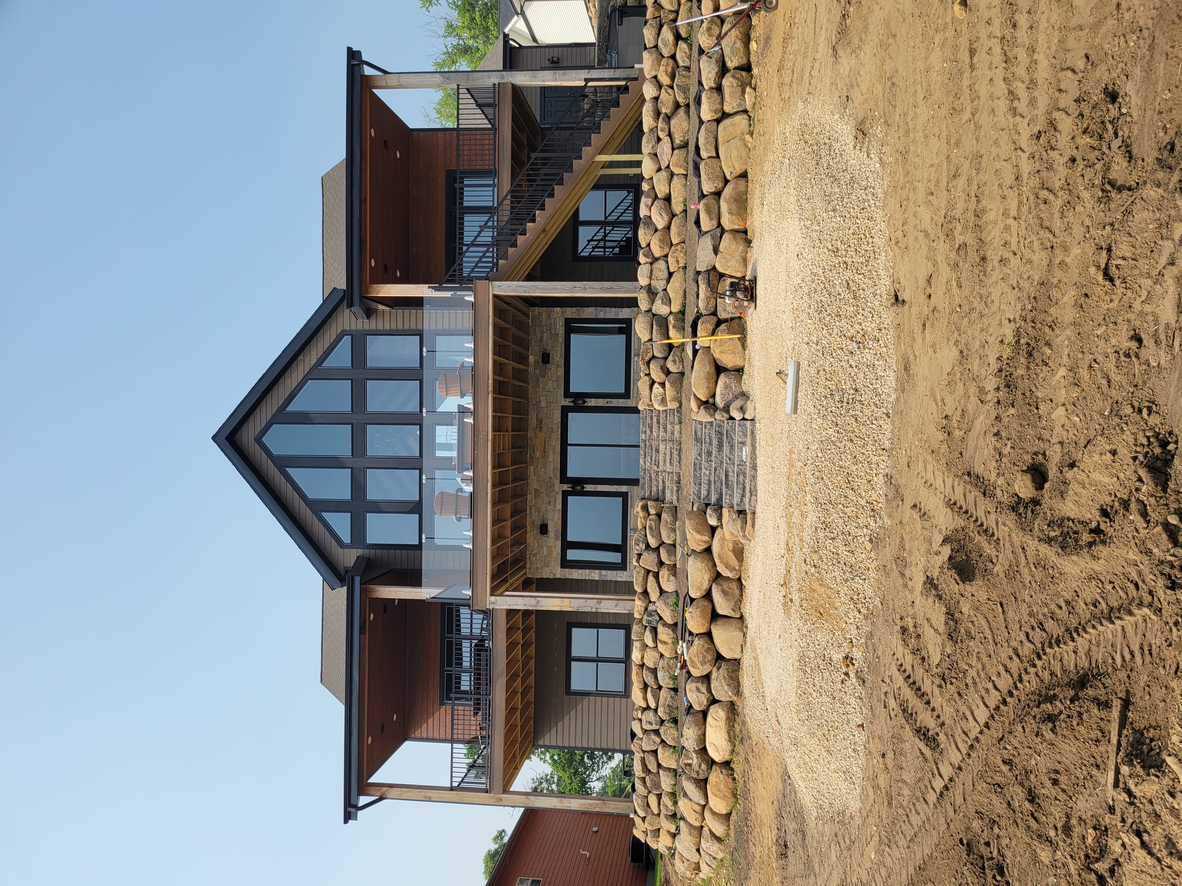 Full front elevation of multi-tier boulder retaining wall at custom home in Dane County, WI