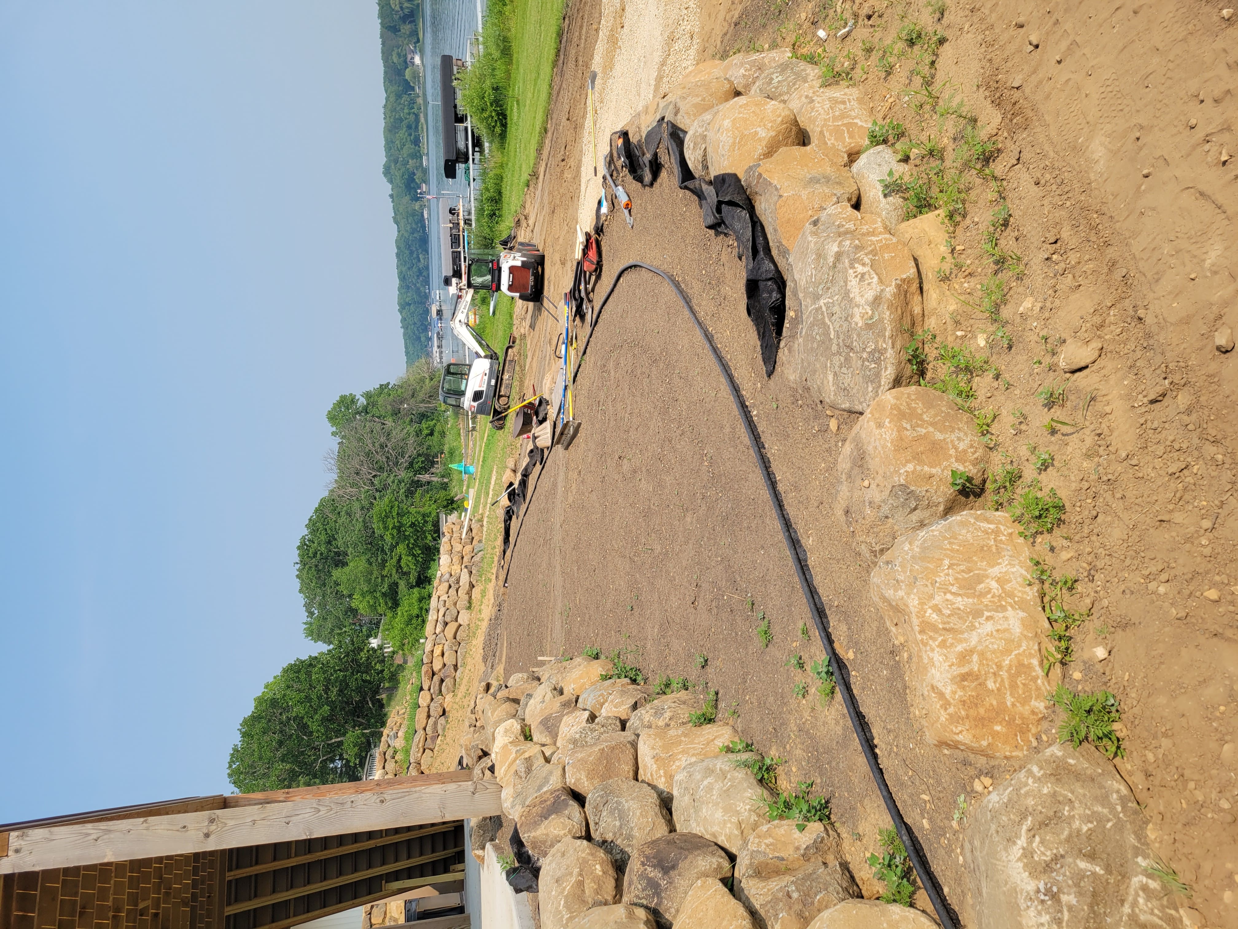 Boulder retaining wall with gravel path installation near lakefront in Dane County, WI