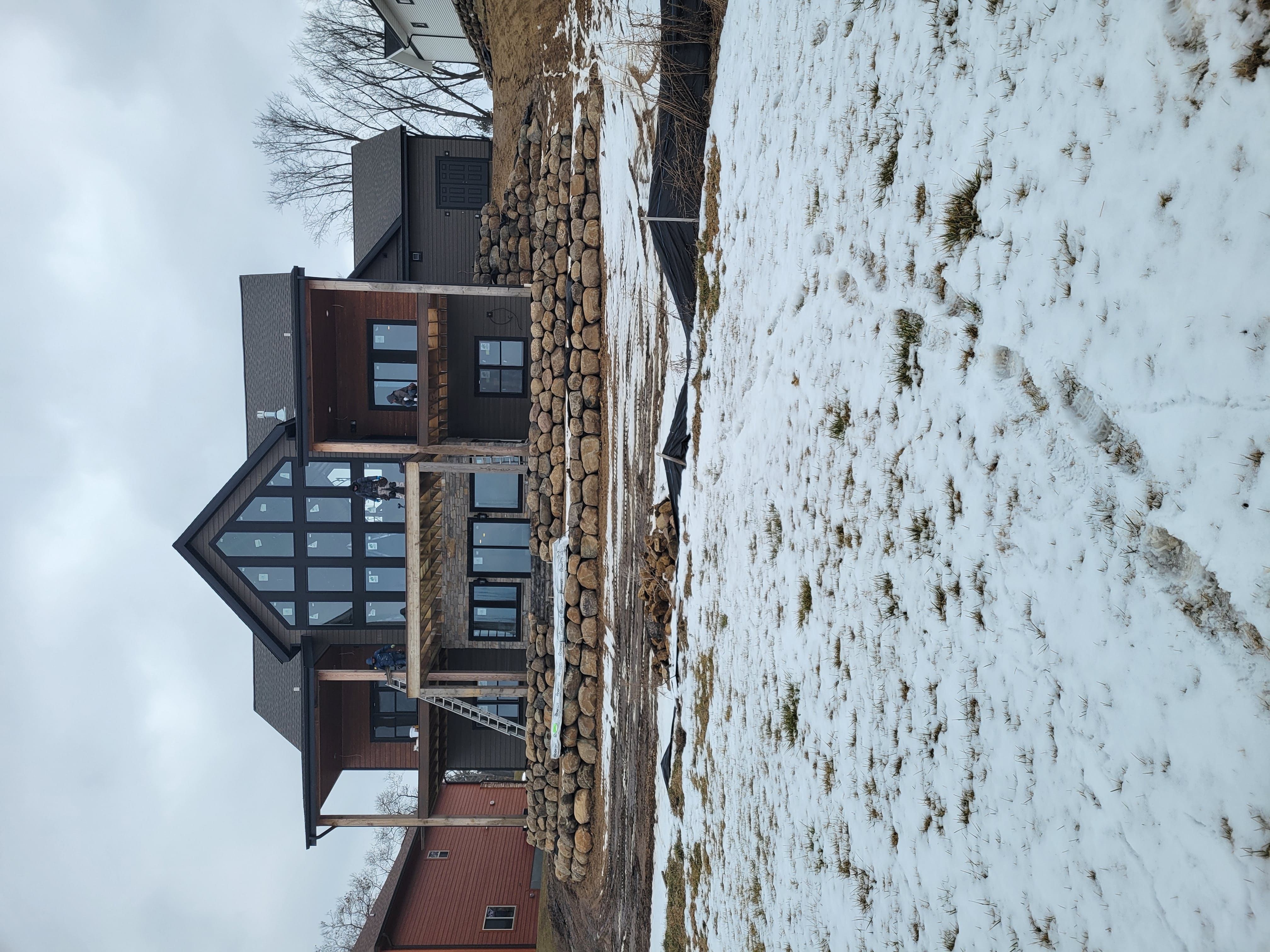 Natural boulder retaining wall installed along a lakeside property in Dane County, WI