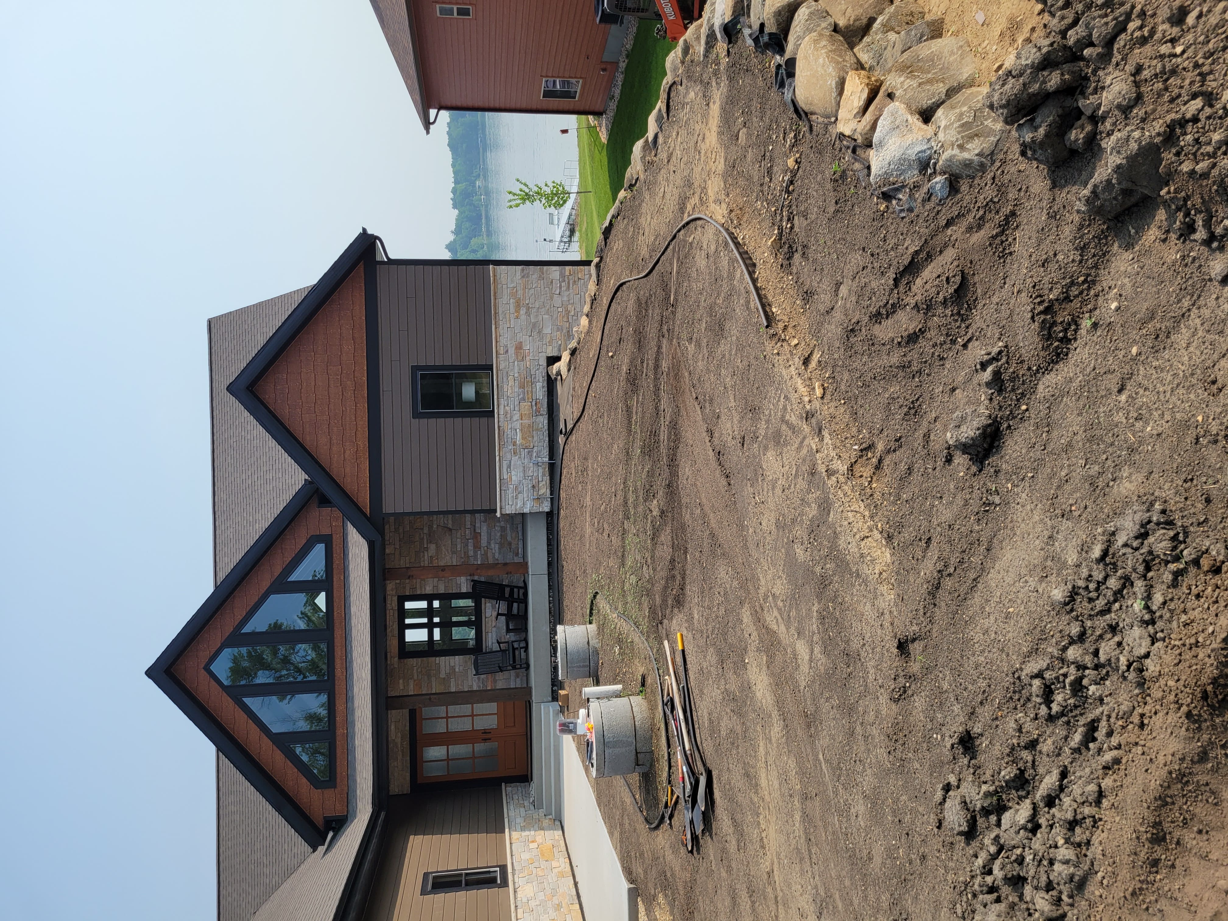 Boulder retaining wall with drainage line installed near lakefront property in Dane County, WI