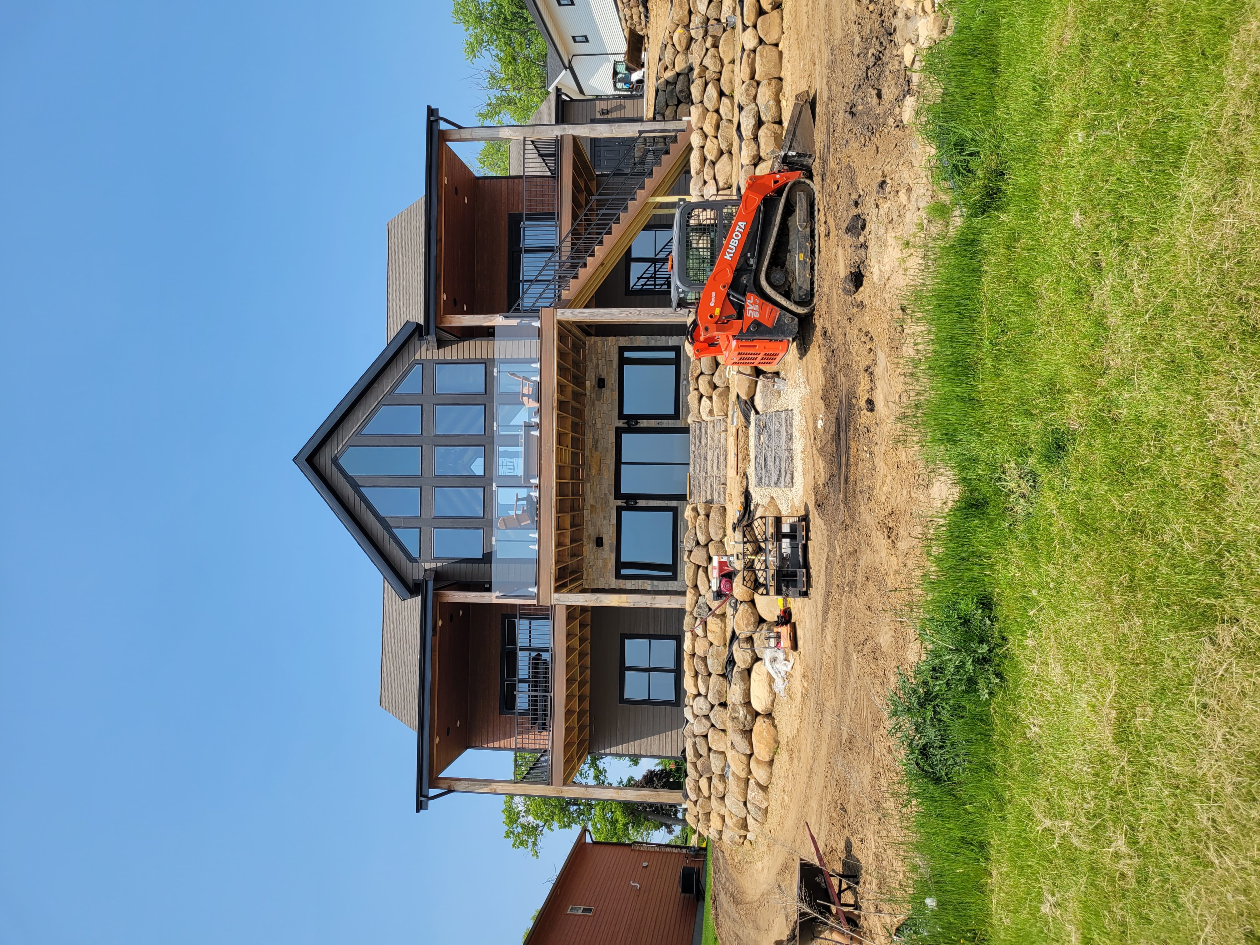 Completed boulder retaining wall along backyard of custom home in Dane County, WI