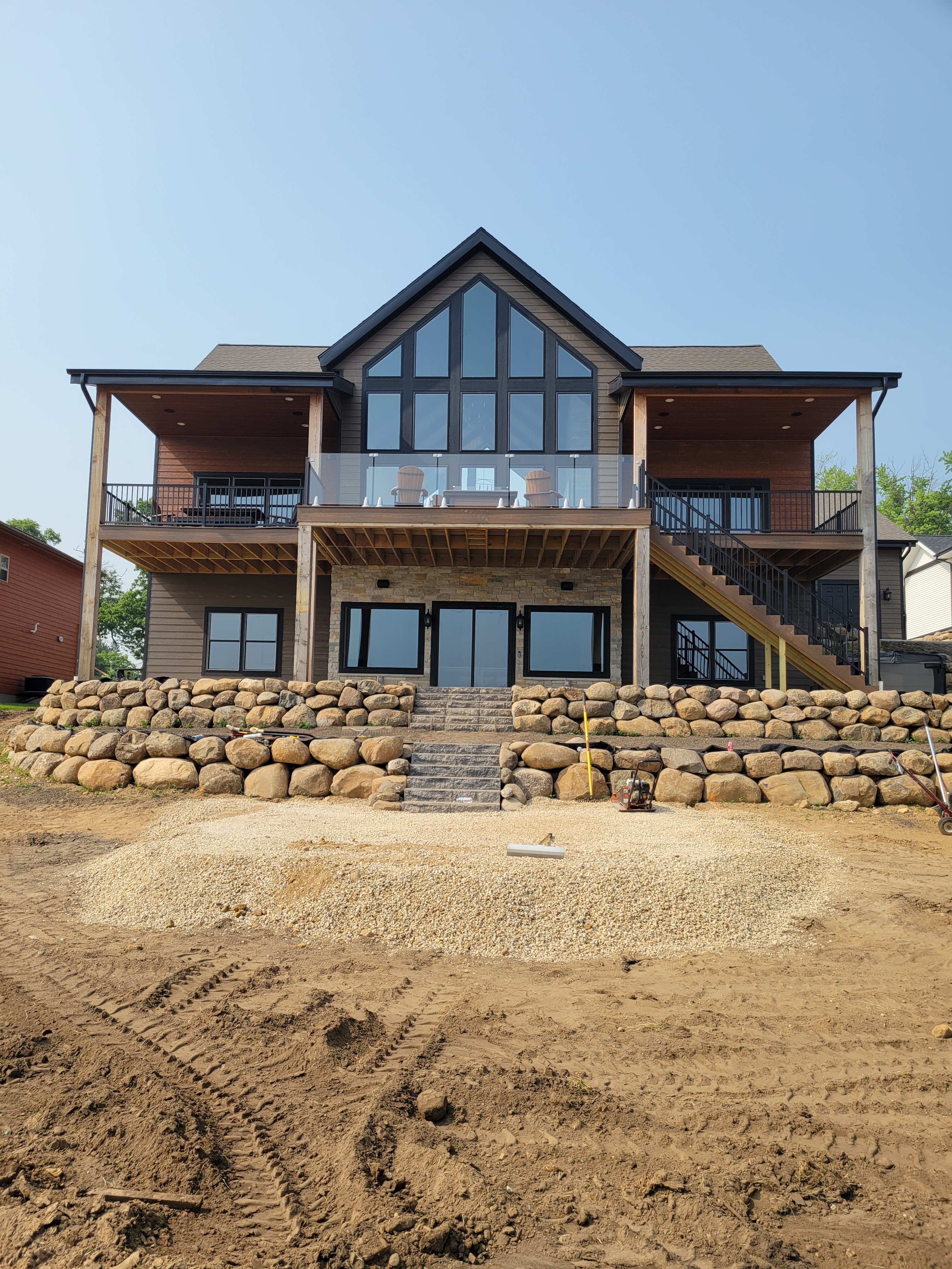 Large natural boulder retaining wall terraces built for a lakeside home in Dane County, WI