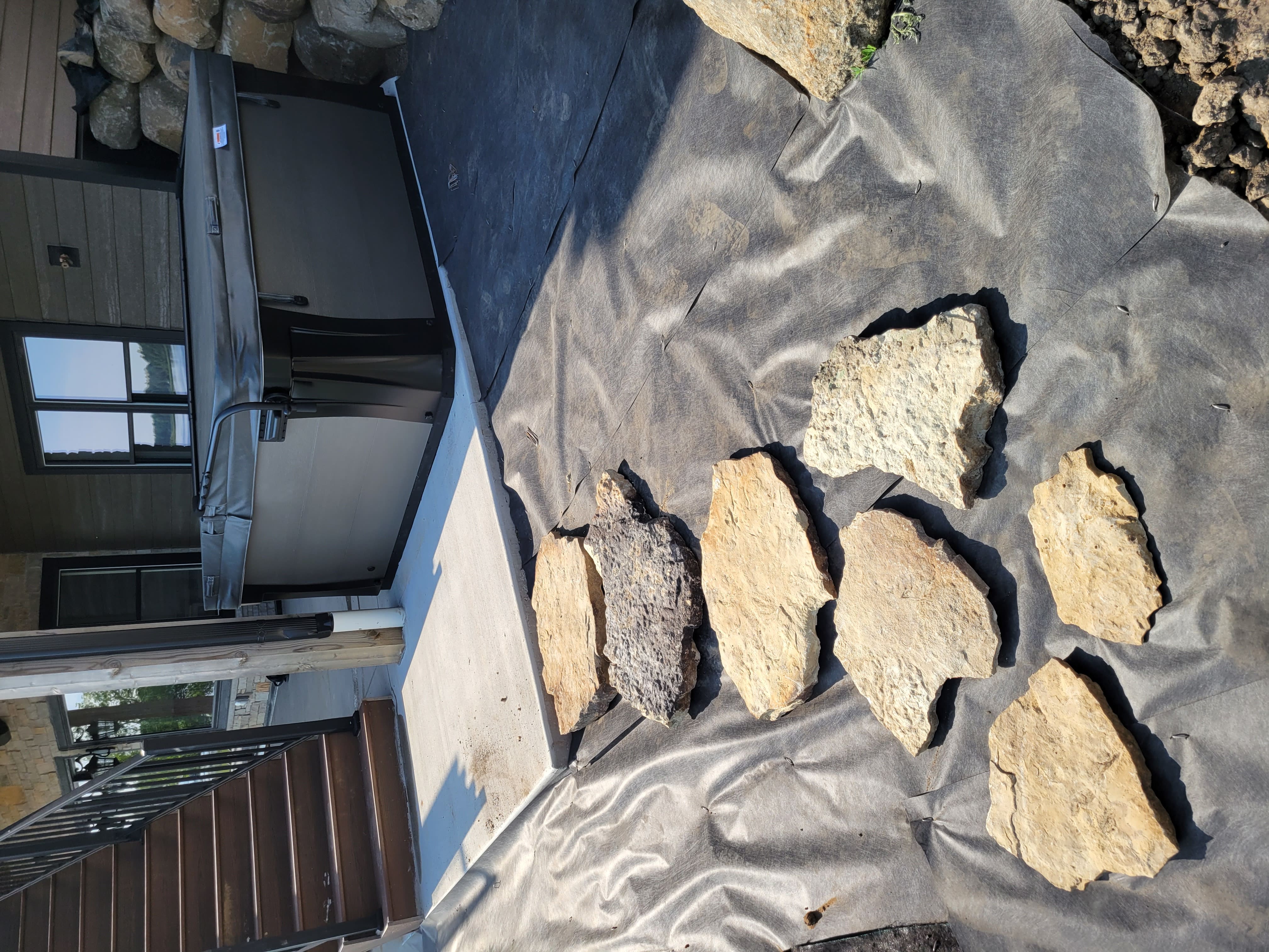 Natural stone slabs staged for retaining wall and patio construction in Dane County, WI