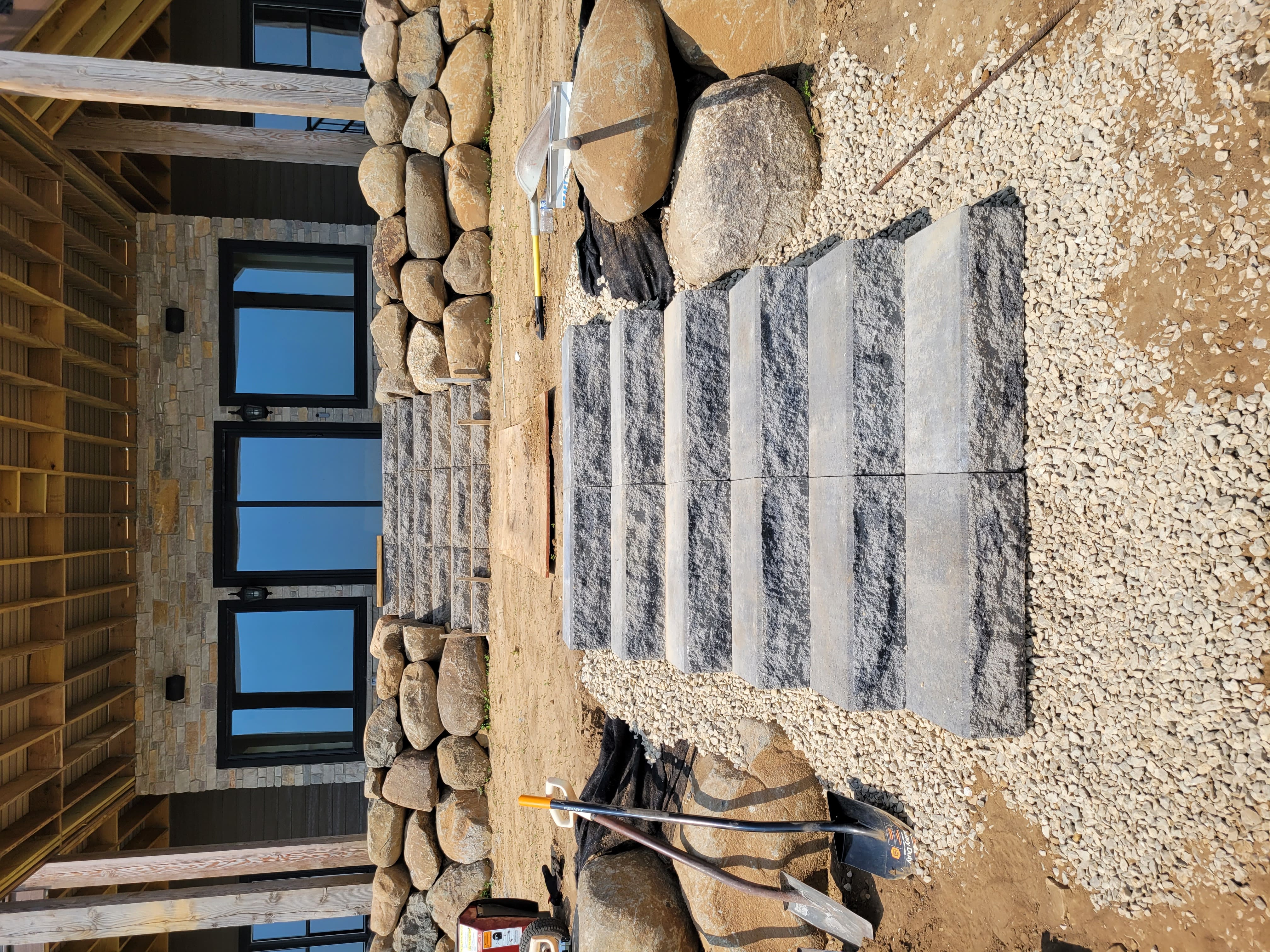 Precision stone step installation and boulder retaining wall in Dane County, WI