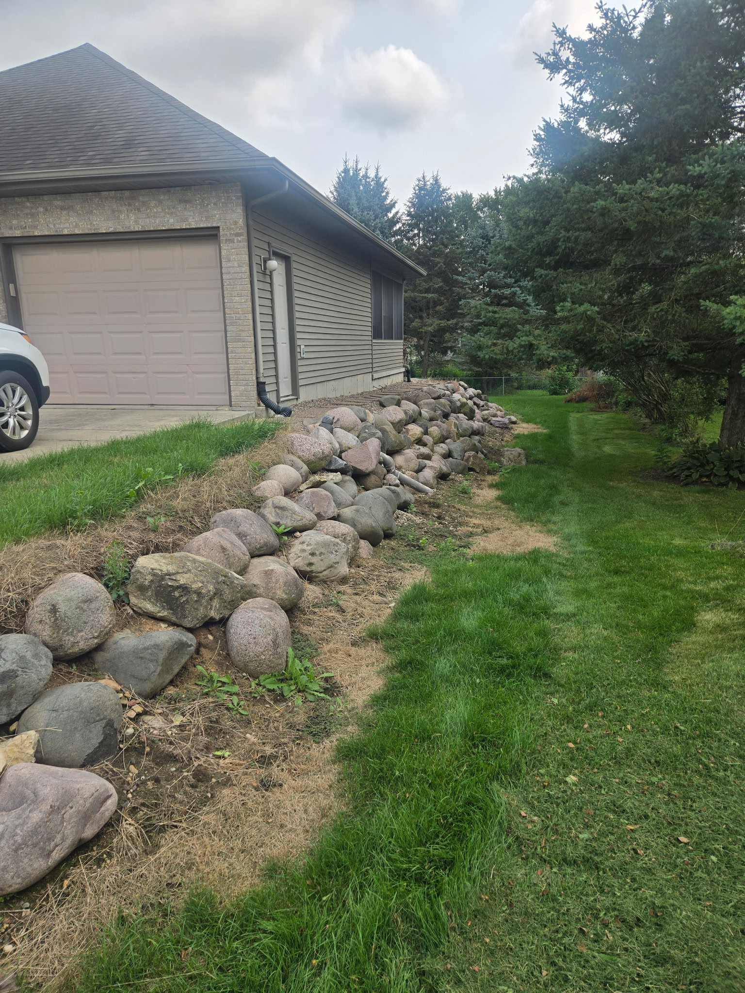 Unstable rock hillside before retaining wall construction