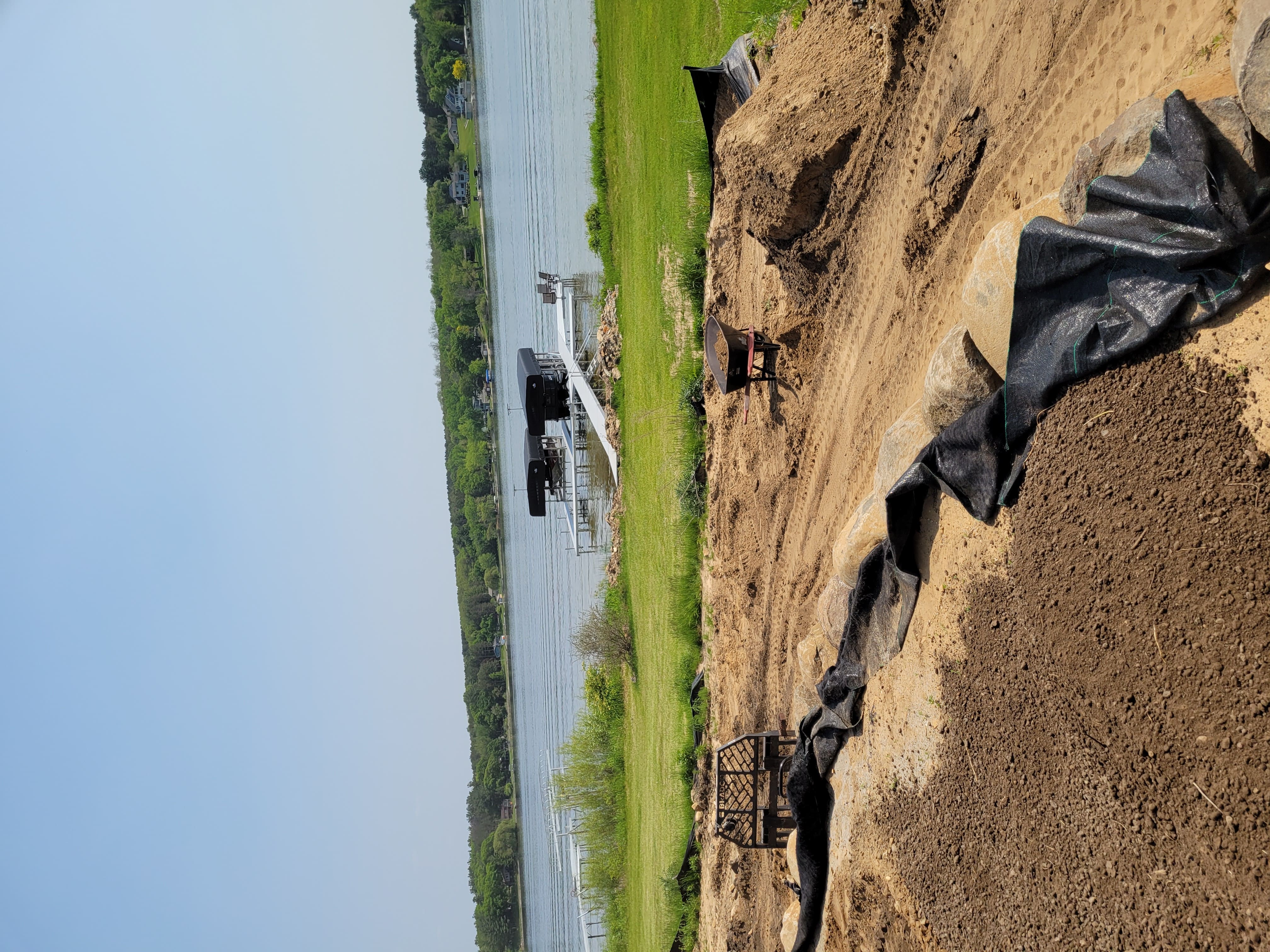 Lakeside yard grading and boulder retaining wall preparation in Dane County, WI