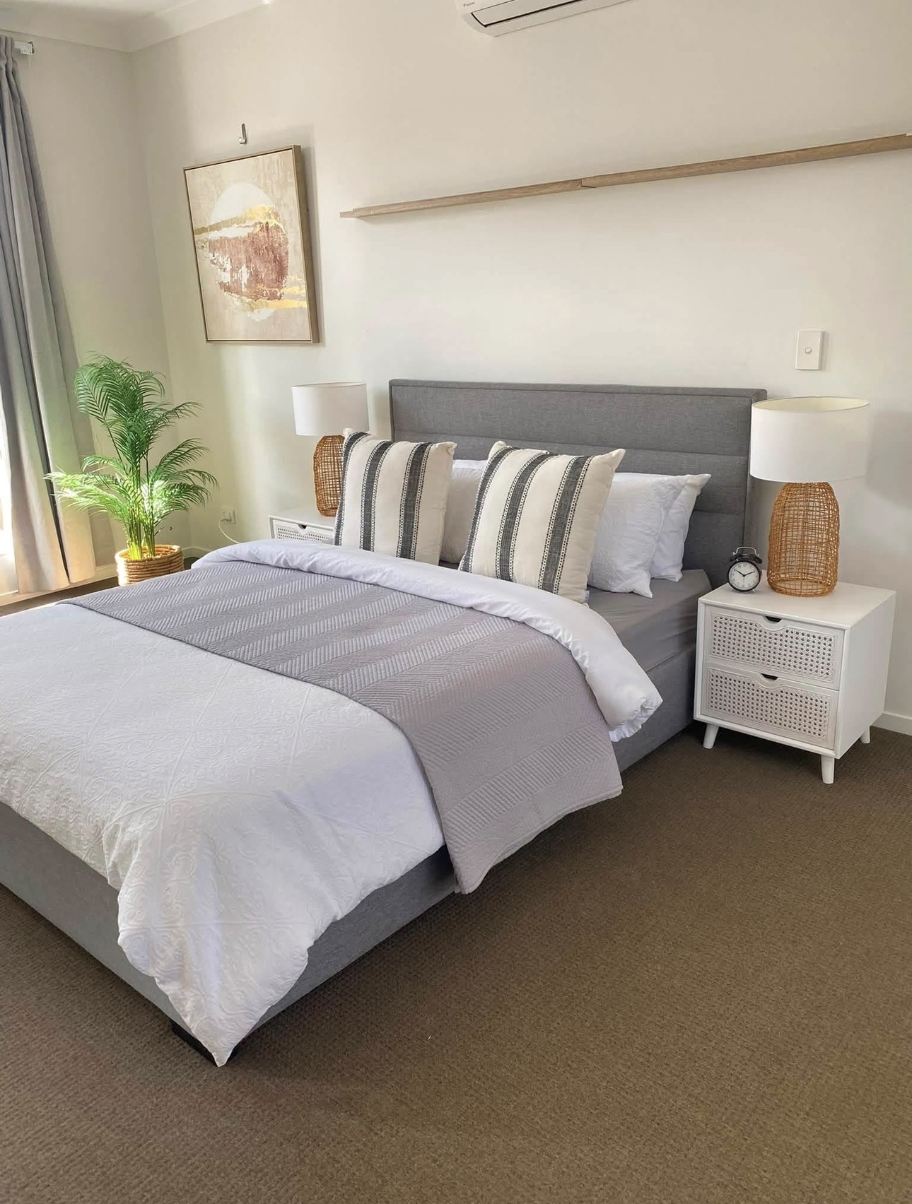 Bedroom with grey upholstered headboard