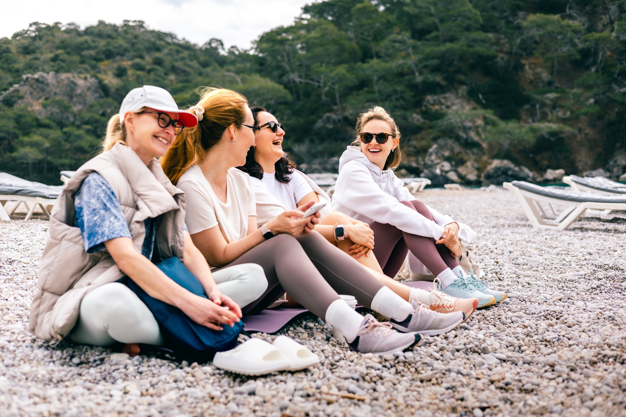 Friends laughing together on beach