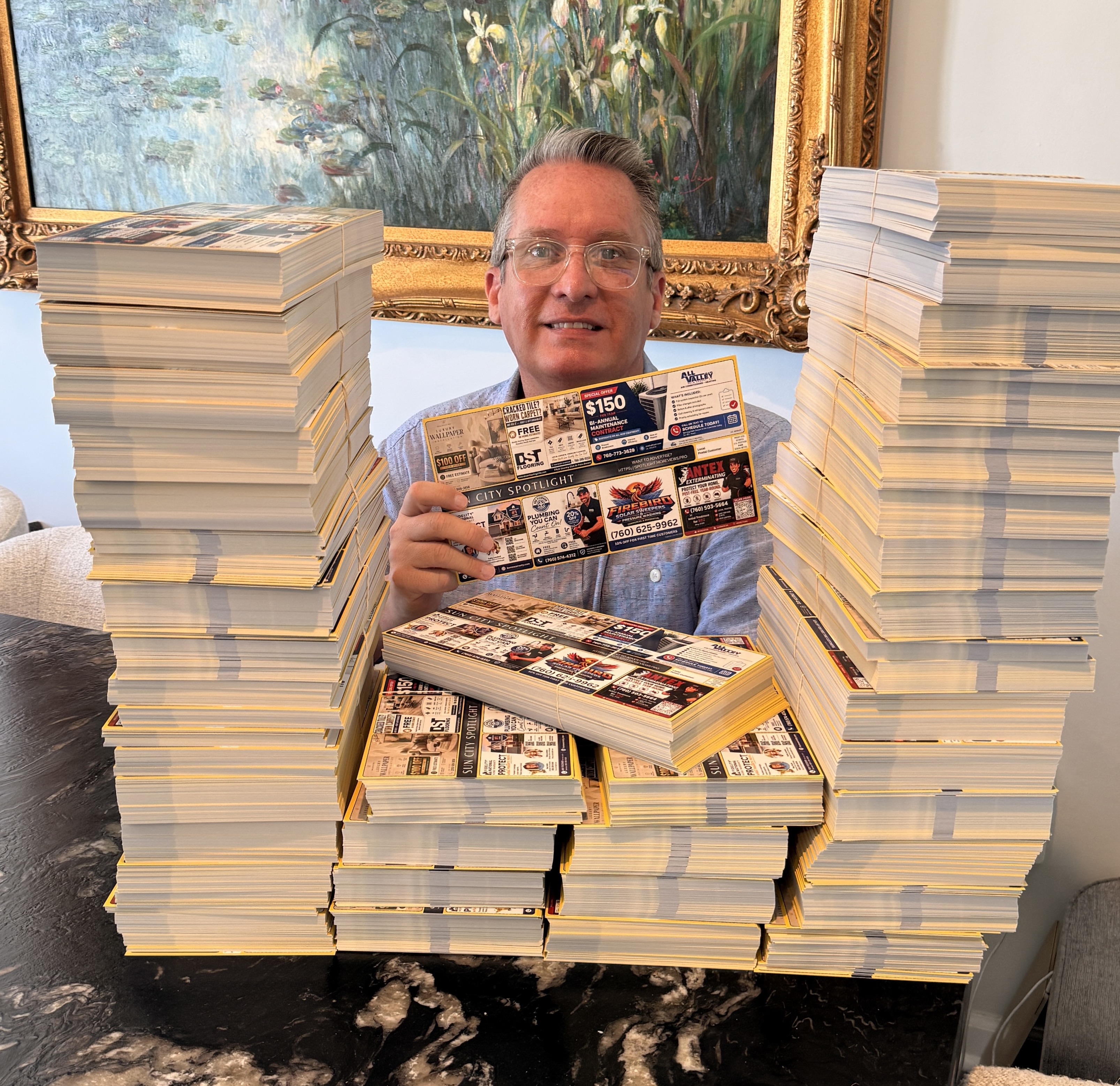 Todd, founder of More Views Pro holding oversized Local Spotlight postcards in Palm Desert