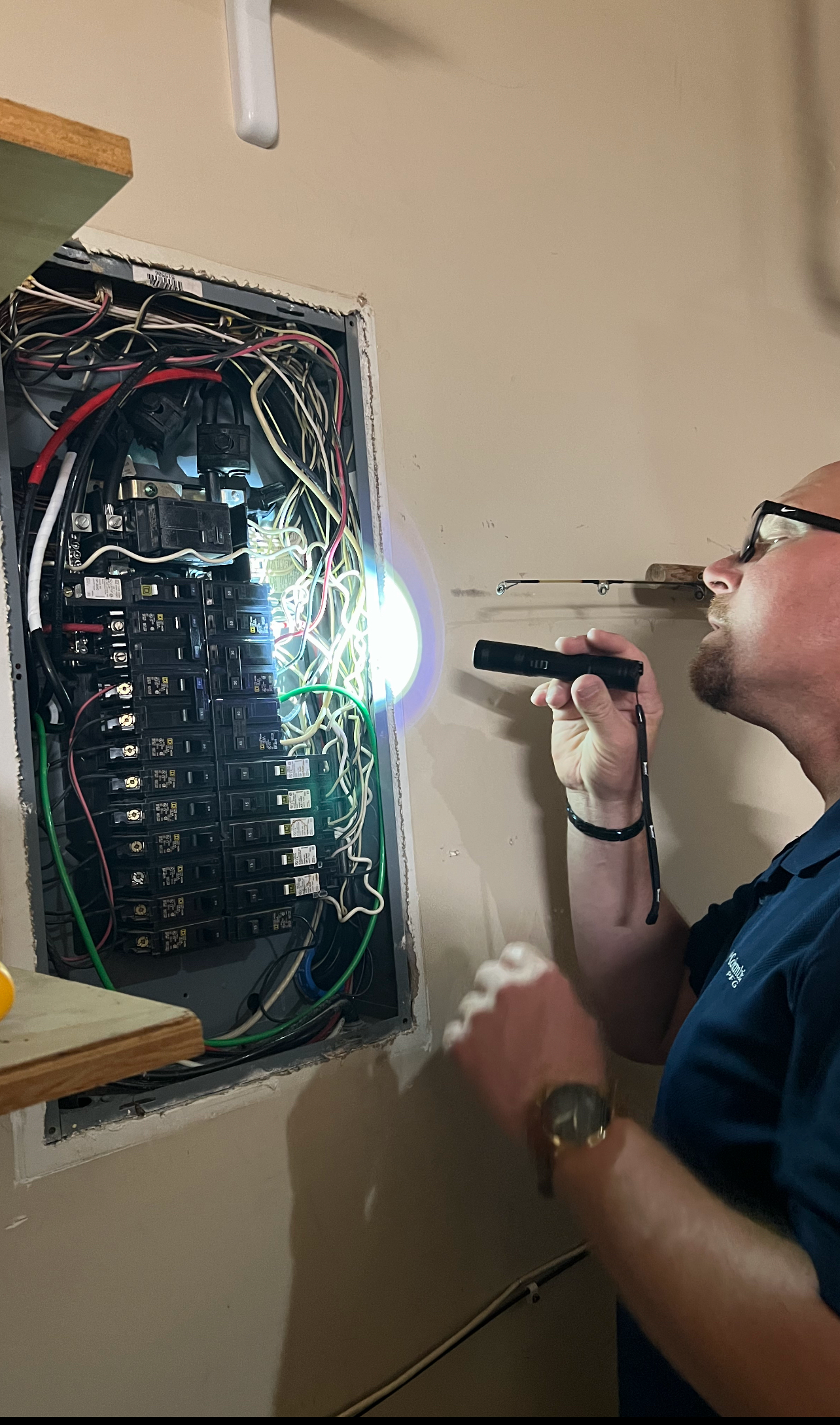 Professional home inspector Dave examining an electrical breaker panel