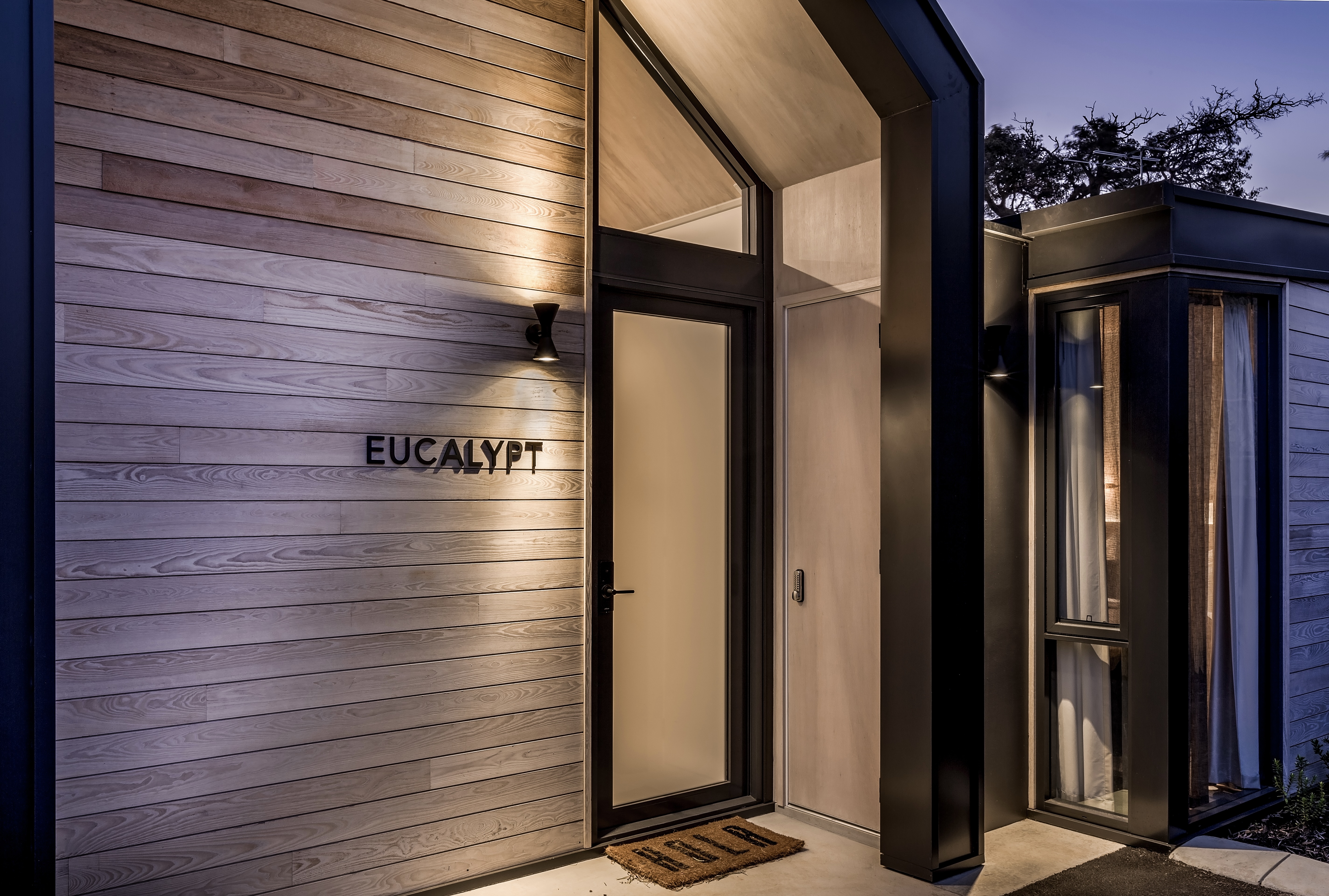 Eucalypt studio entry with horizontal burnt ash timber cladding