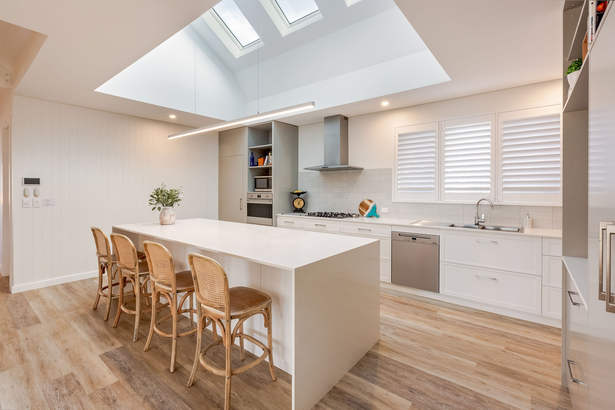 Coastal kitchen with feature skylight and island seating