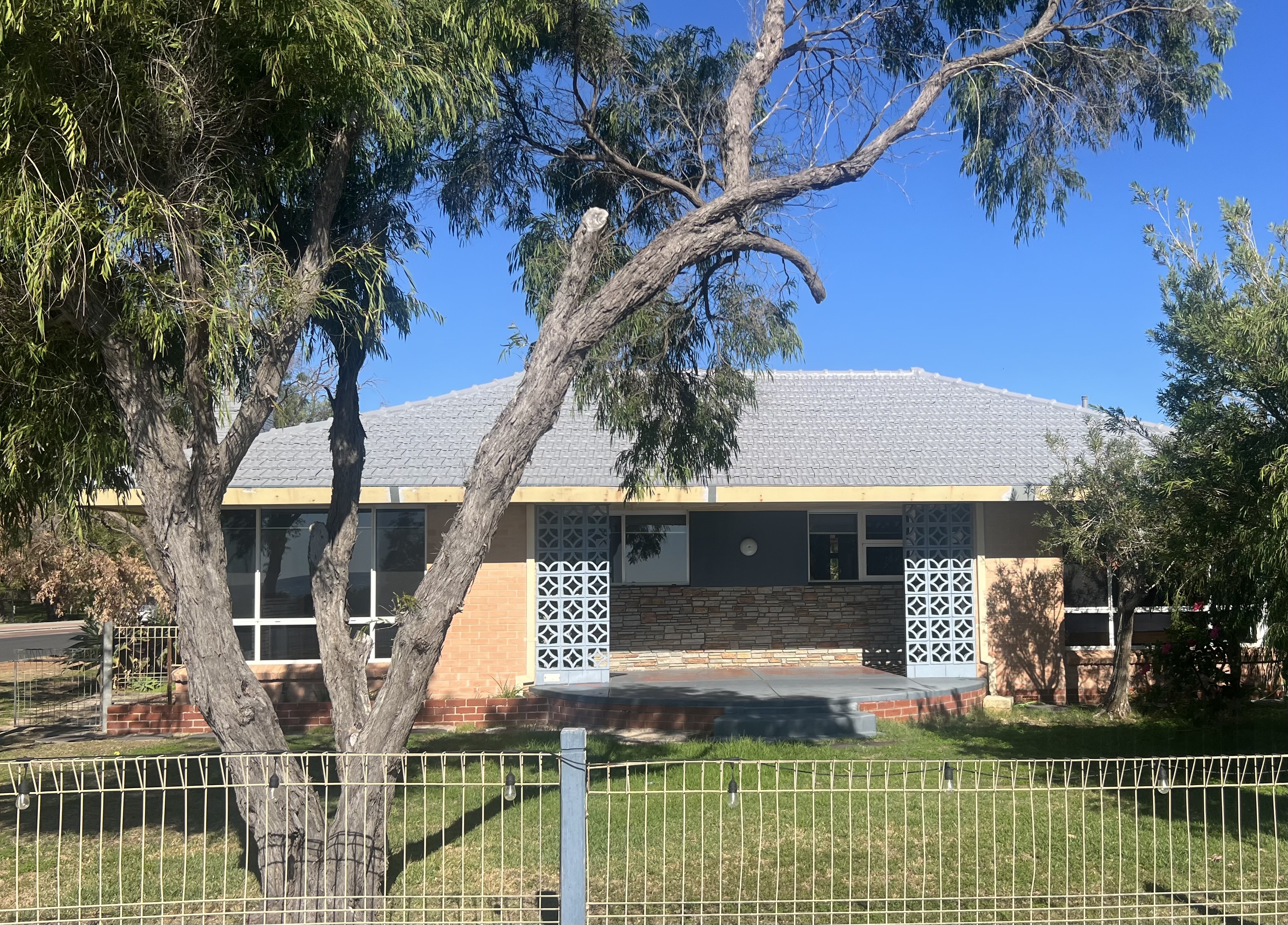 Geographe Rd home before renovation, showing original brick veneer, breeze block screens and low-pitched tiled roof