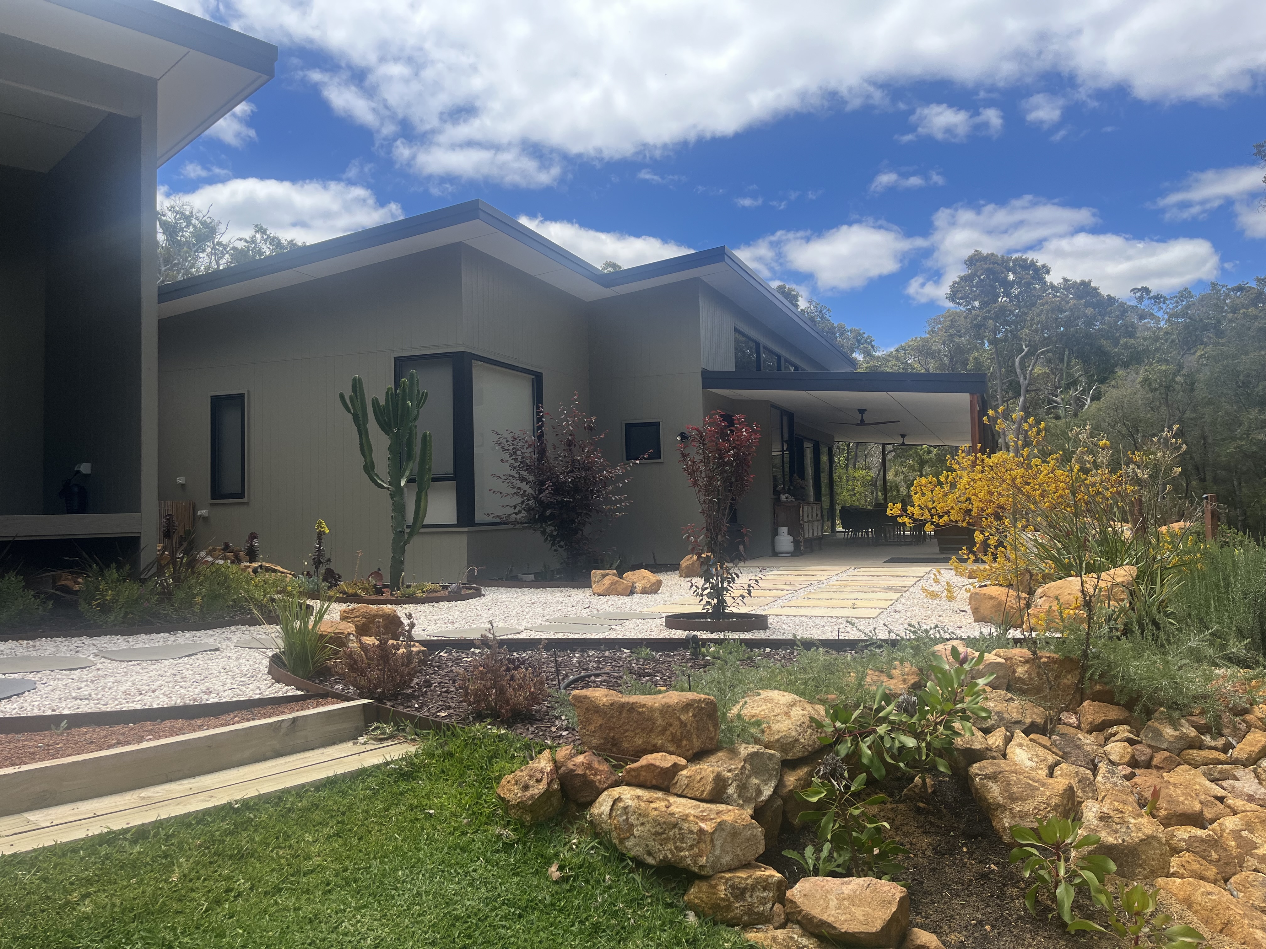 Exterior view of the lodge with covered alfresco and native garden