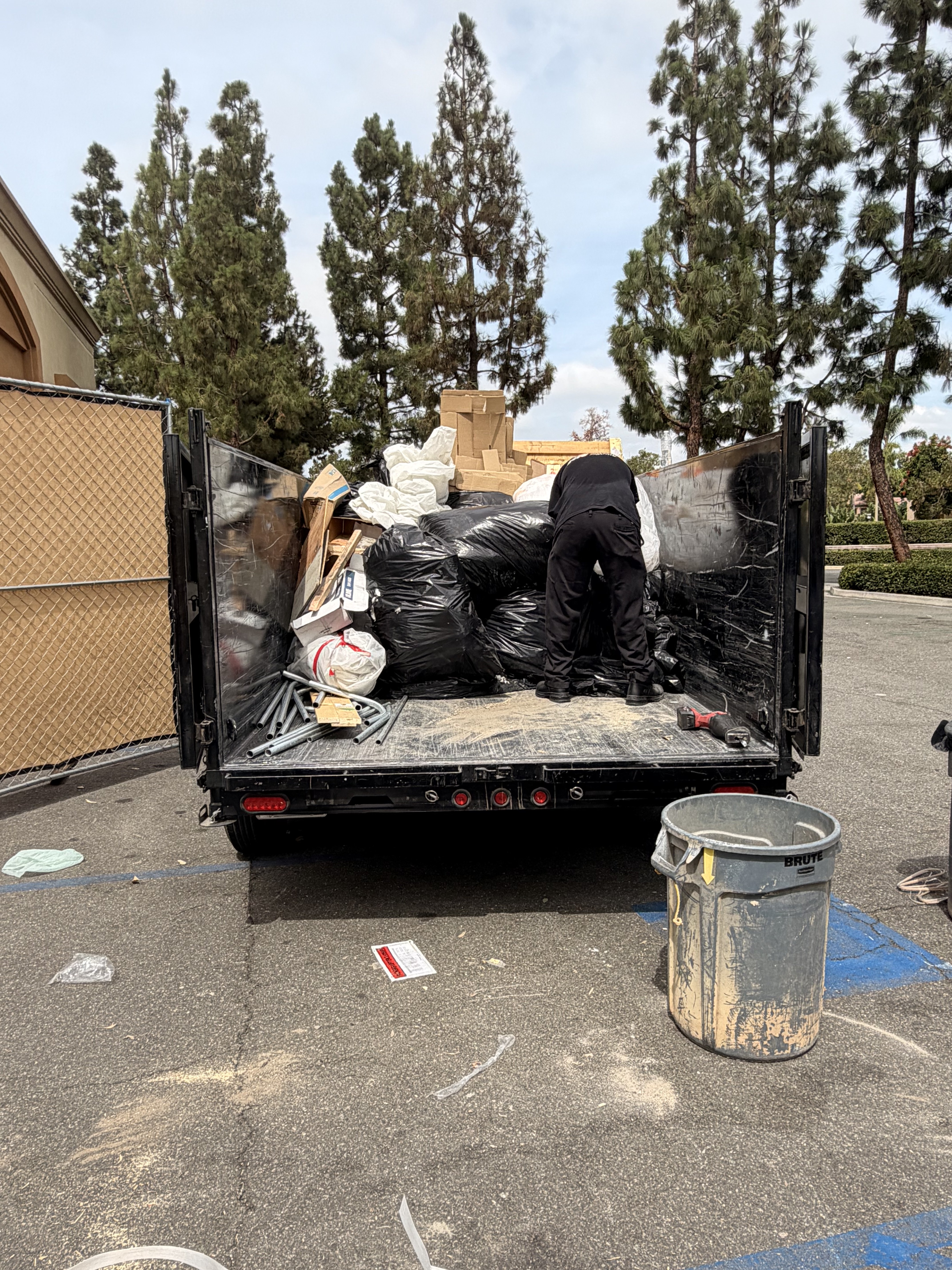 Dump trailer fully loaded with debris from Irvine commercial property