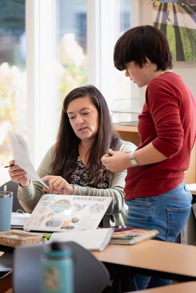 Classroom assistant training session — a guide and assistant collaborating in a Montessori prepared environment