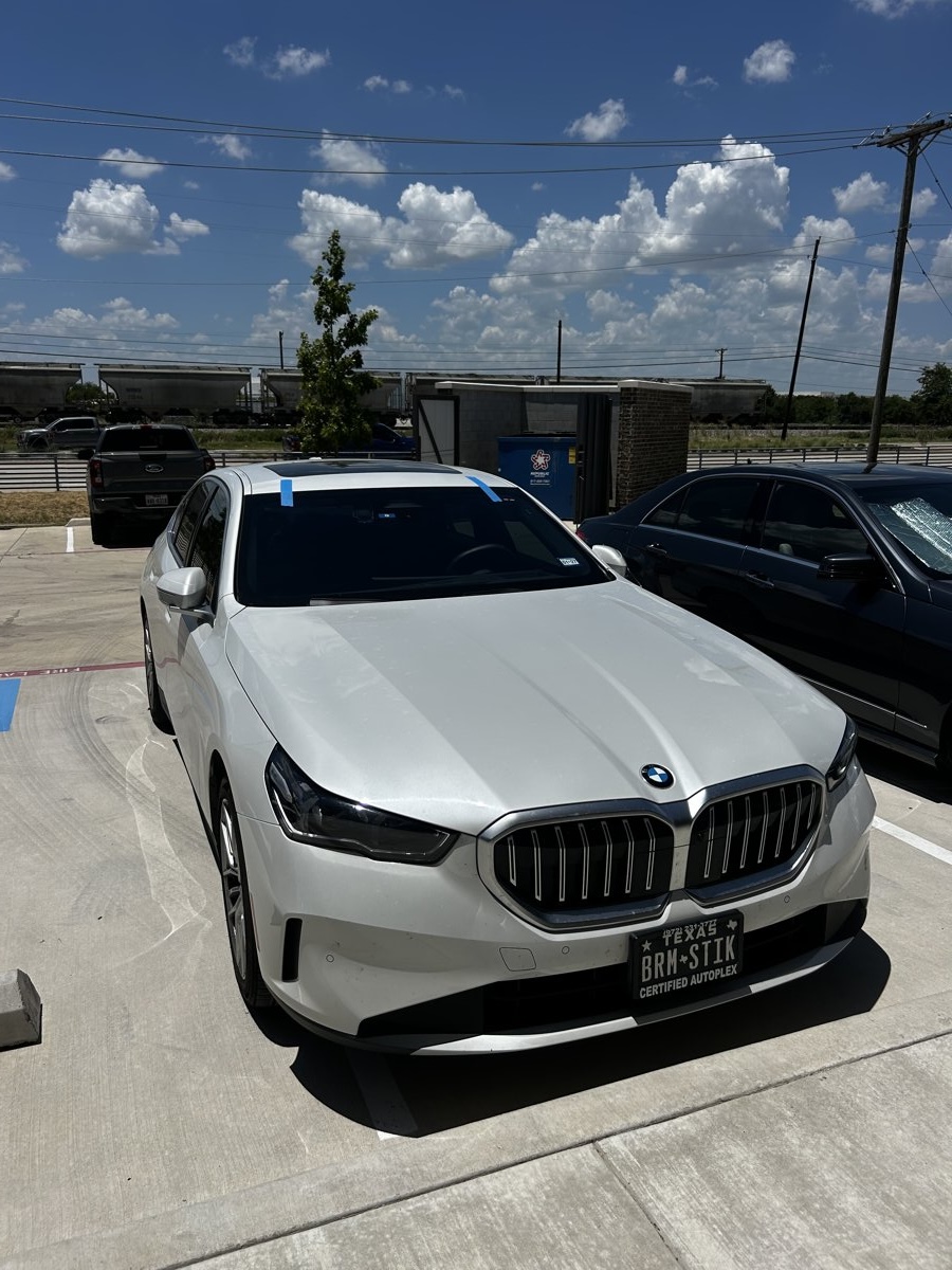 Buddy's Auto Glass completed windshield replacement on white BMW in North Texas parking lot